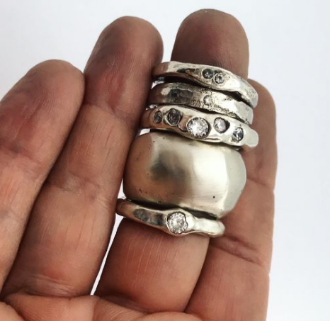 hand with silver rings stacked